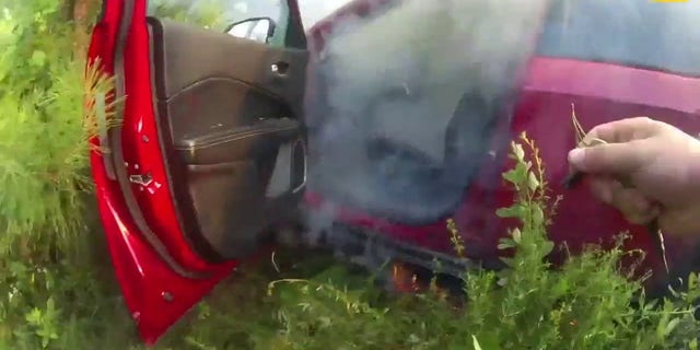 Smoke filling a red car