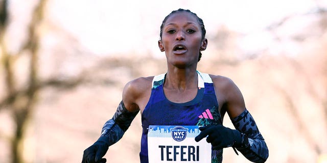 Senbere Teferi crosses the finish line at a race in New York