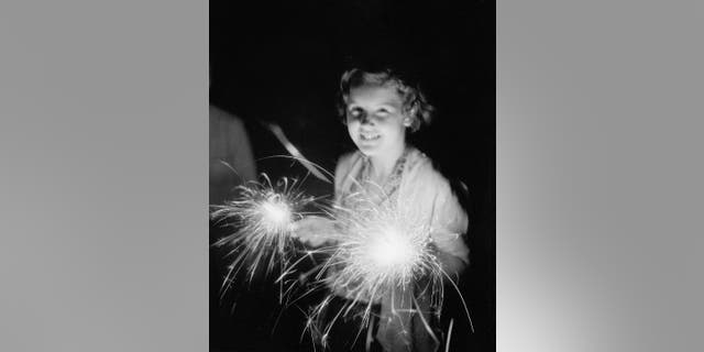 Girl holds 4th of July sparkler