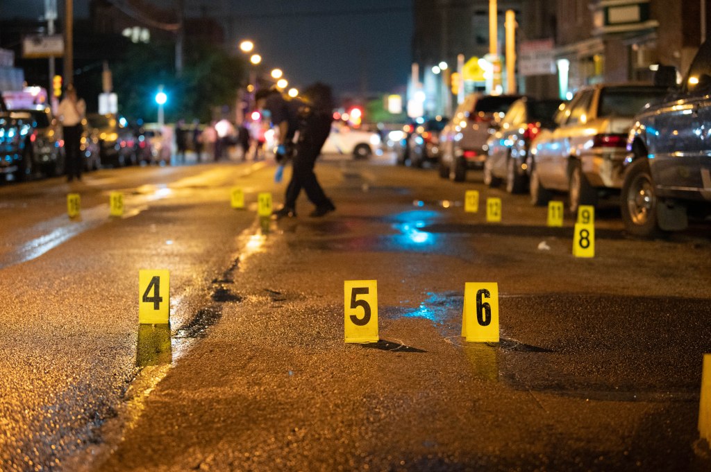 Police work the scene of a deadly shooting in Philadelphia that left four men dead and two kids wounded. 