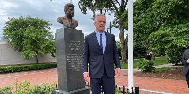 Robert F. Kennedy stands alongside bust of his late uncle, President John F. Kennedy